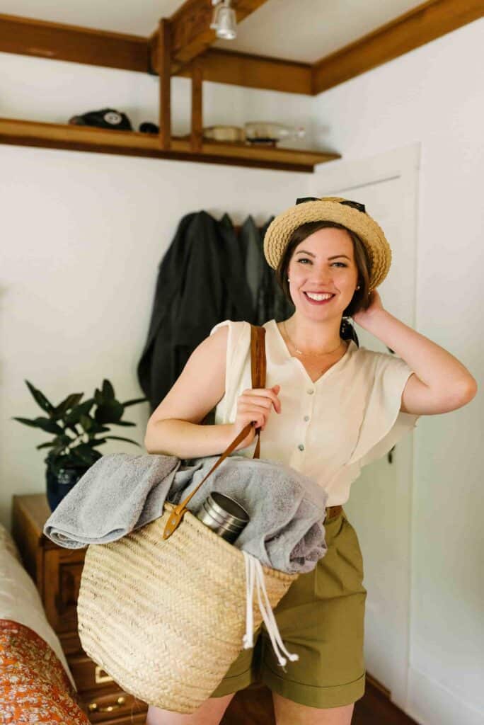 A woman packed for the beach, included sustainable beach towels